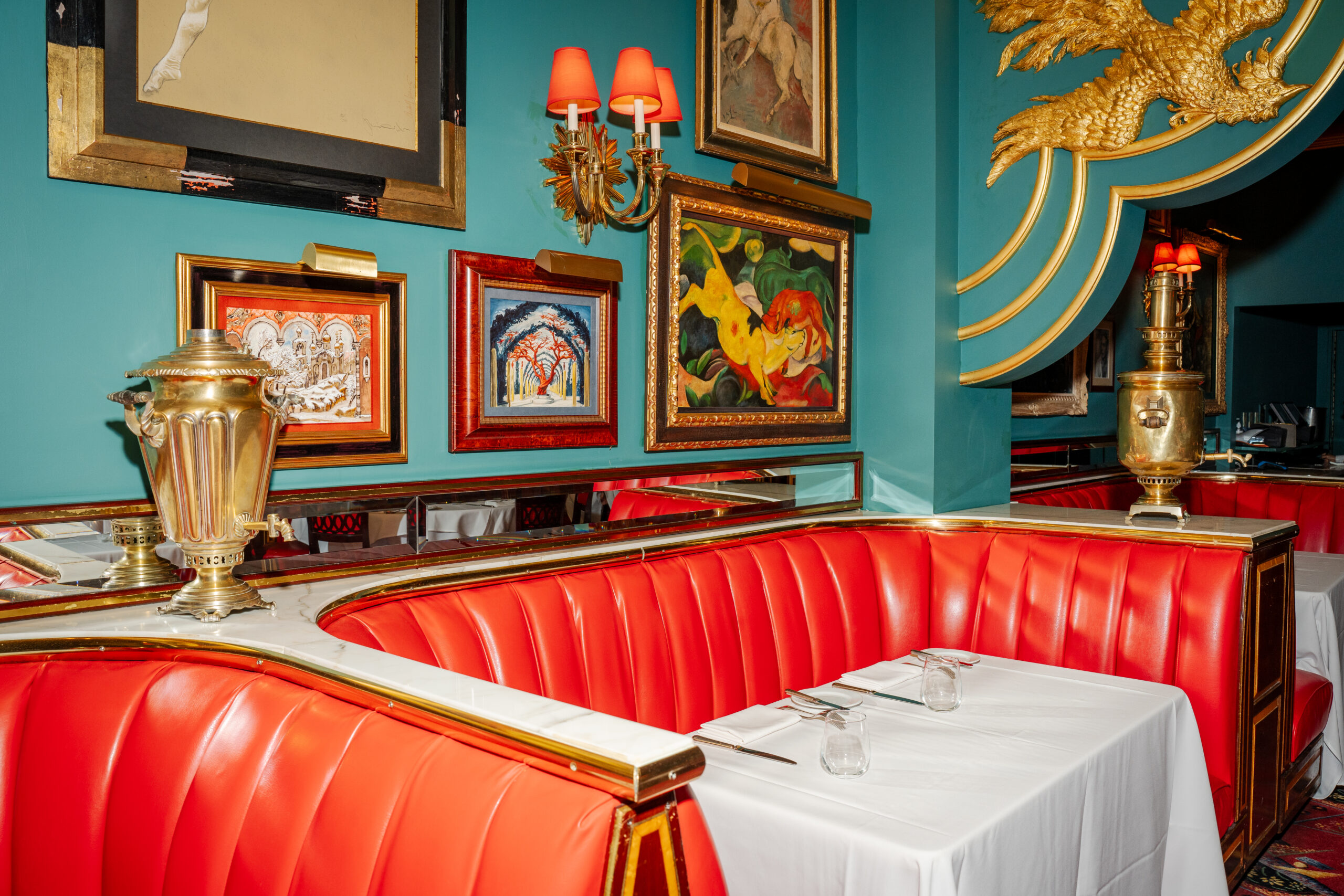 Vibrant red booths and ornate decor in The Russian Tea Room interior