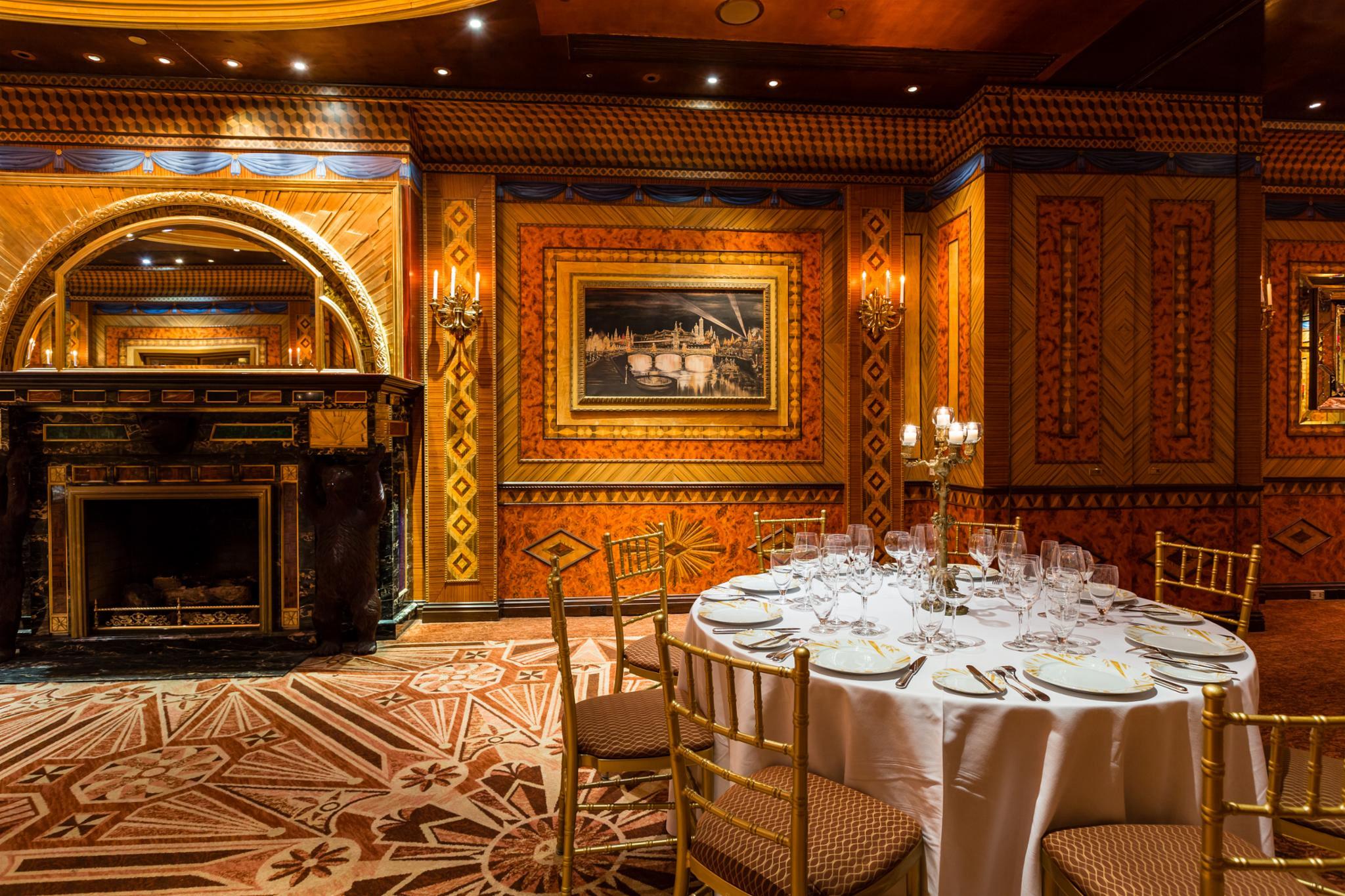 Hearth Room 1 Elegant dining room with ornate wood paneling and a fireplace